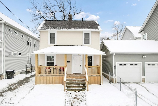 view of front property featuring a garage and a porch