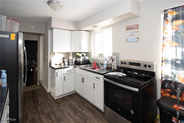 kitchen featuring appliances with stainless steel finishes, sink, white cabinets, and dark hardwood / wood-style flooring