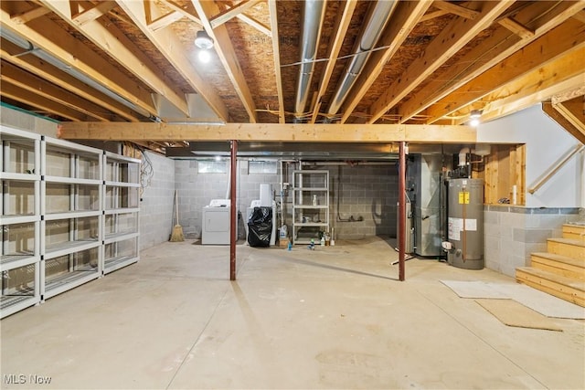 basement with gas water heater, heating unit, and washing machine and clothes dryer