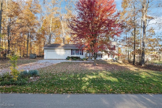 view of front of house with a garage and a front yard