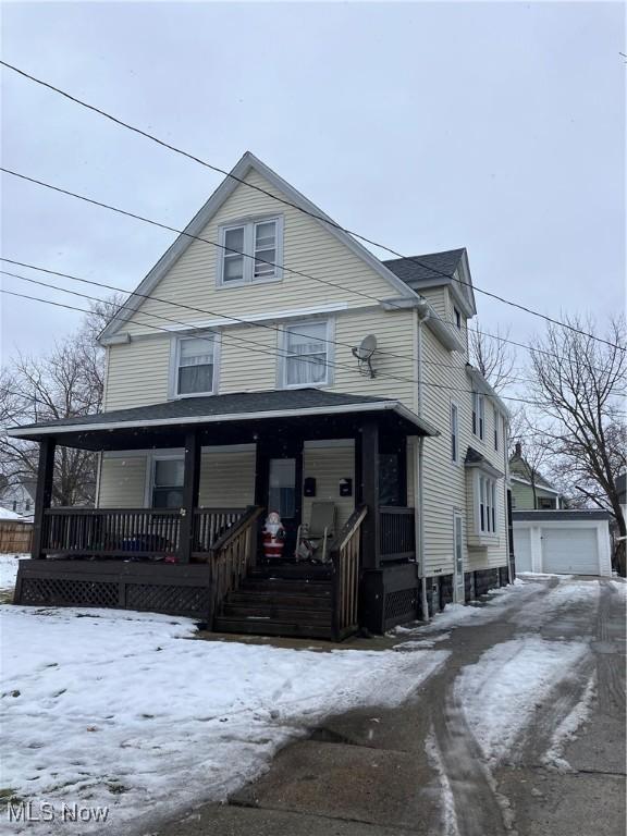 view of front of home featuring an outbuilding, a garage, and a porch