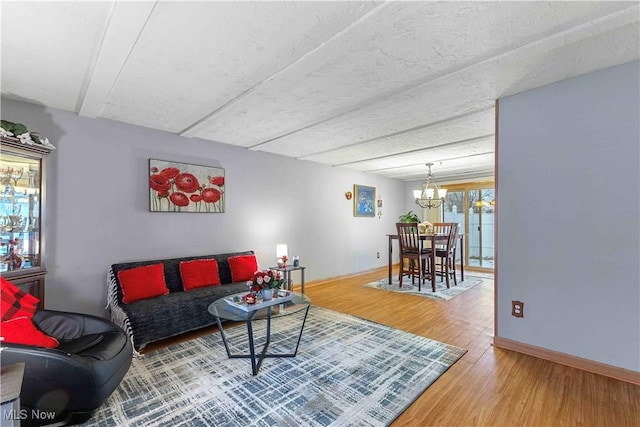 living room with an inviting chandelier and hardwood / wood-style flooring