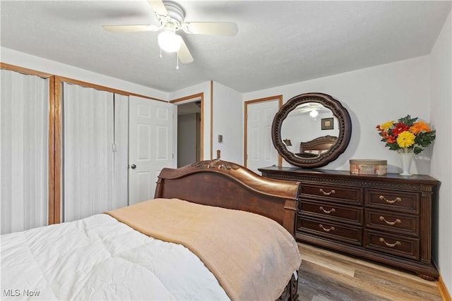 bedroom featuring ceiling fan, light hardwood / wood-style floors, and a textured ceiling