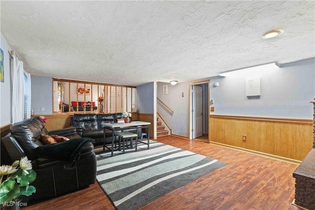 living room with hardwood / wood-style flooring and a textured ceiling