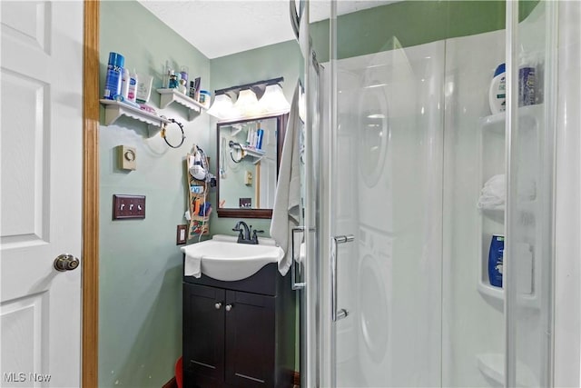 bathroom featuring vanity and a shower with door