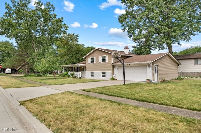 tri-level home with a garage and a front lawn