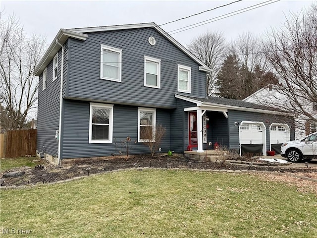 view of property featuring a garage and a front yard