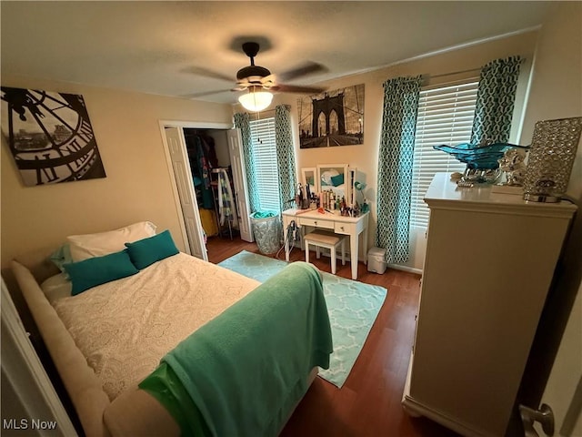 bedroom featuring wood-type flooring, a closet, and ceiling fan