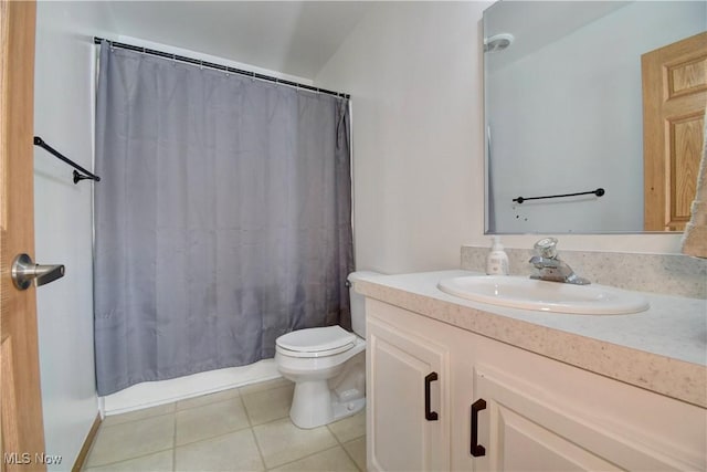 bathroom featuring tile patterned flooring, vanity, and toilet