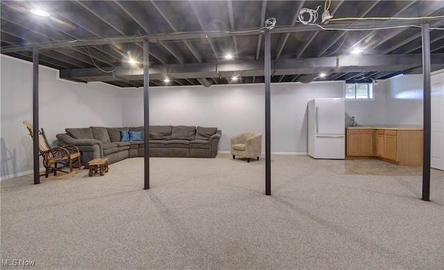 basement featuring white refrigerator and light carpet