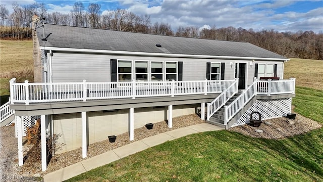 back of house with a wooden deck and a yard