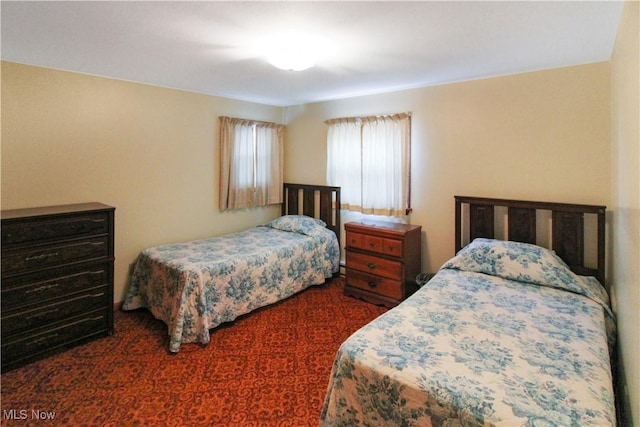 bedroom featuring dark colored carpet