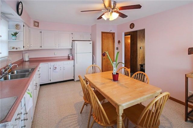 dining room with ceiling fan and sink