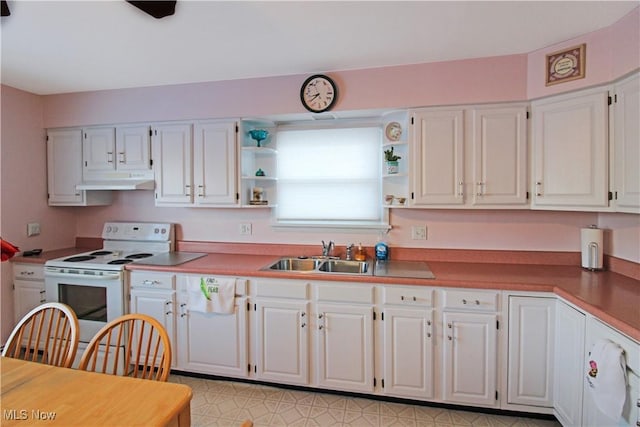 kitchen featuring white cabinets, sink, and electric range