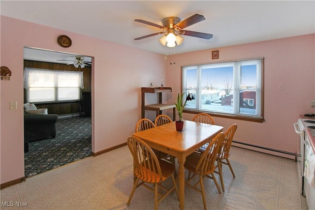 dining room with baseboard heating and ceiling fan