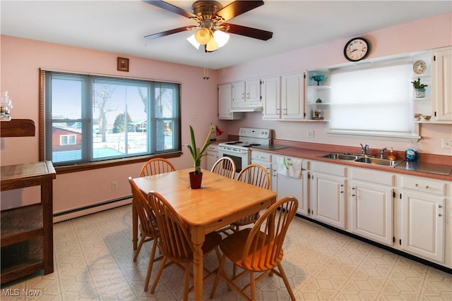 dining area with a baseboard heating unit, sink, and ceiling fan