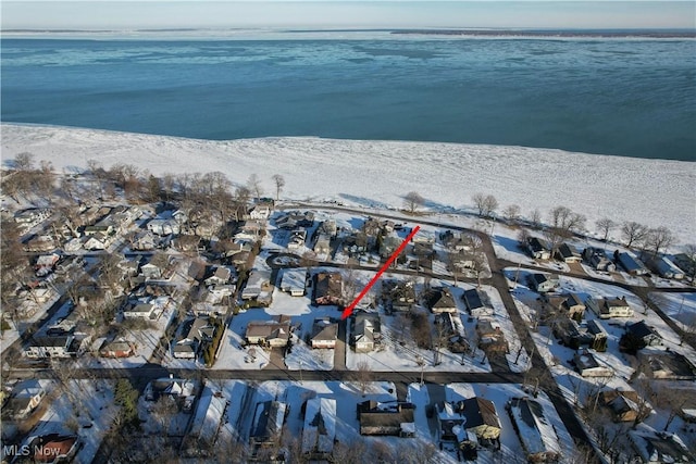 drone / aerial view with a water view and a beach view