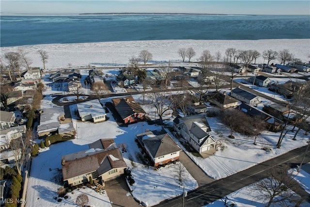 snowy aerial view featuring a water view