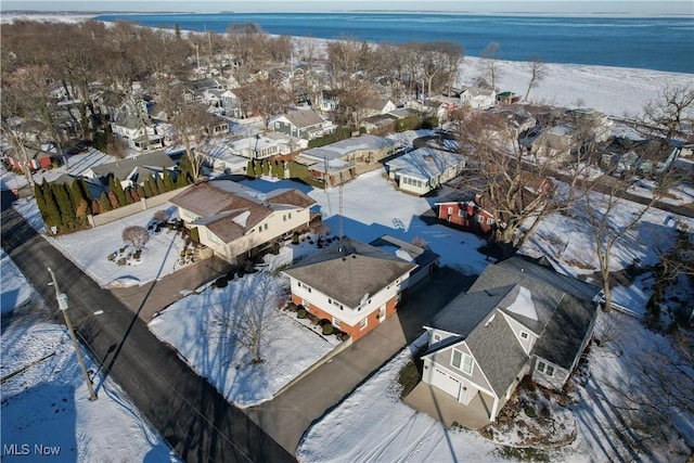 snowy aerial view featuring a water view