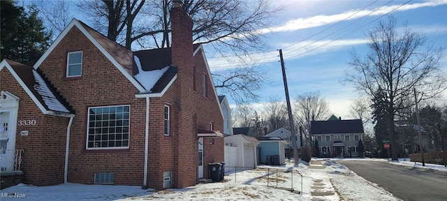 view of snow covered exterior featuring a garage