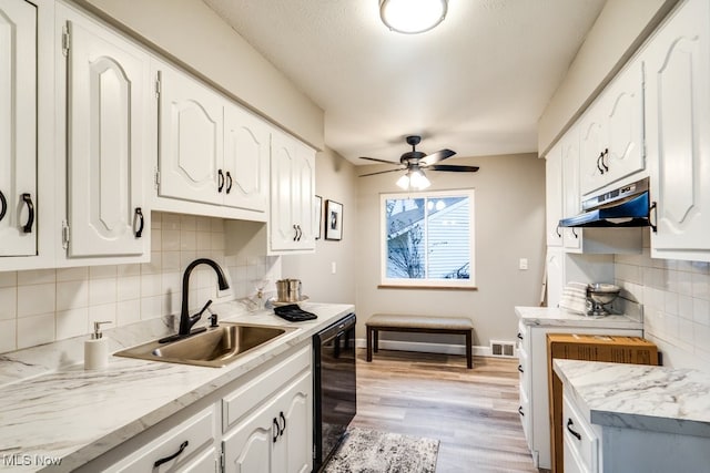 kitchen featuring tasteful backsplash, sink, white cabinets, ceiling fan, and light hardwood / wood-style floors