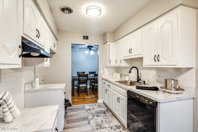 kitchen featuring sink, black dishwasher, ceiling fan, light hardwood / wood-style floors, and white cabinets