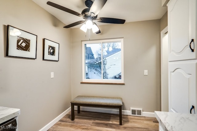 living area featuring ceiling fan and light hardwood / wood-style floors