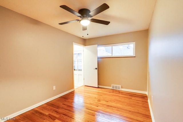 empty room featuring ceiling fan and light hardwood / wood-style floors