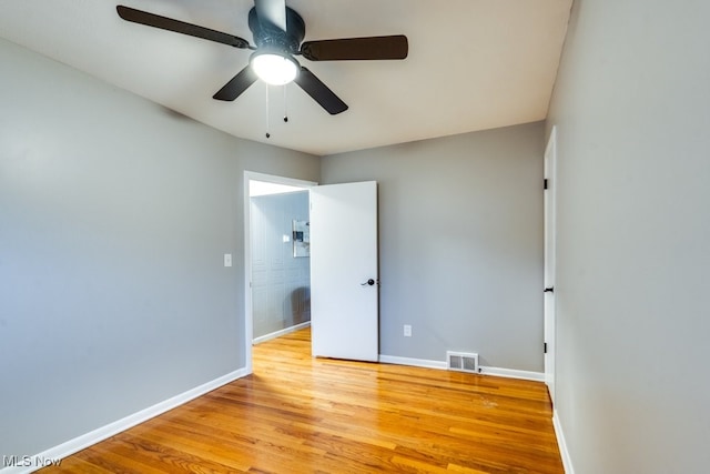 unfurnished room with ceiling fan and light wood-type flooring