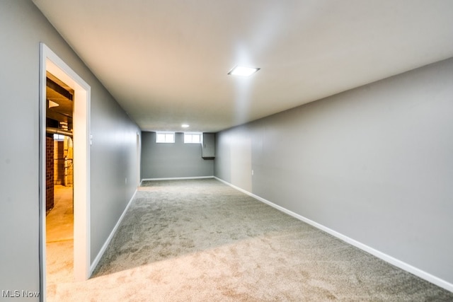 basement featuring light colored carpet