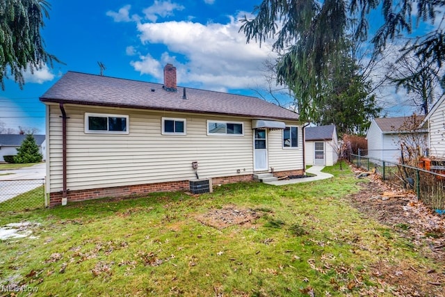 rear view of house featuring a yard and central air condition unit