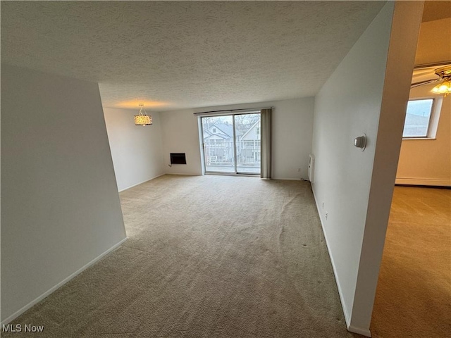 carpeted spare room featuring a textured ceiling