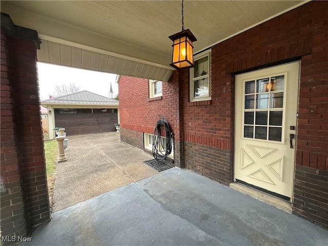 view of patio / terrace with a garage and an outdoor structure