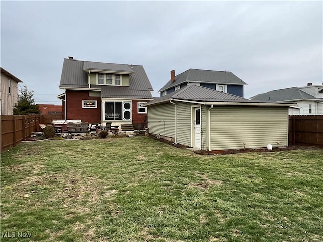 rear view of house featuring a lawn