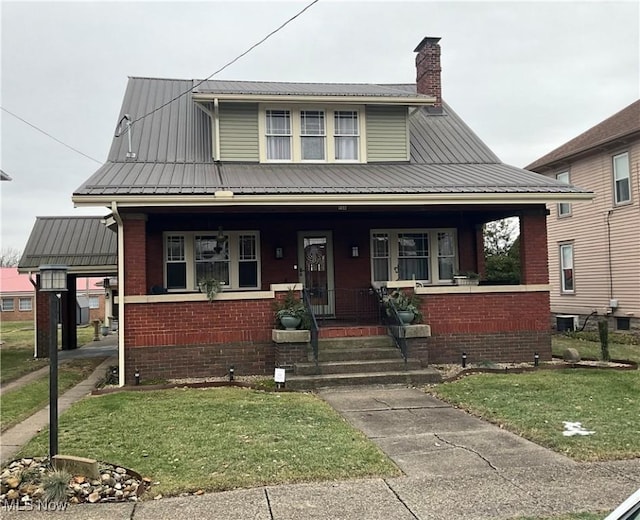 bungalow-style home with a front lawn and a porch