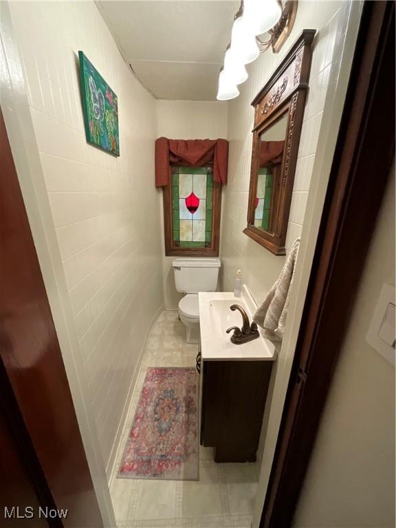 bathroom with vanity, toilet, and tile patterned flooring