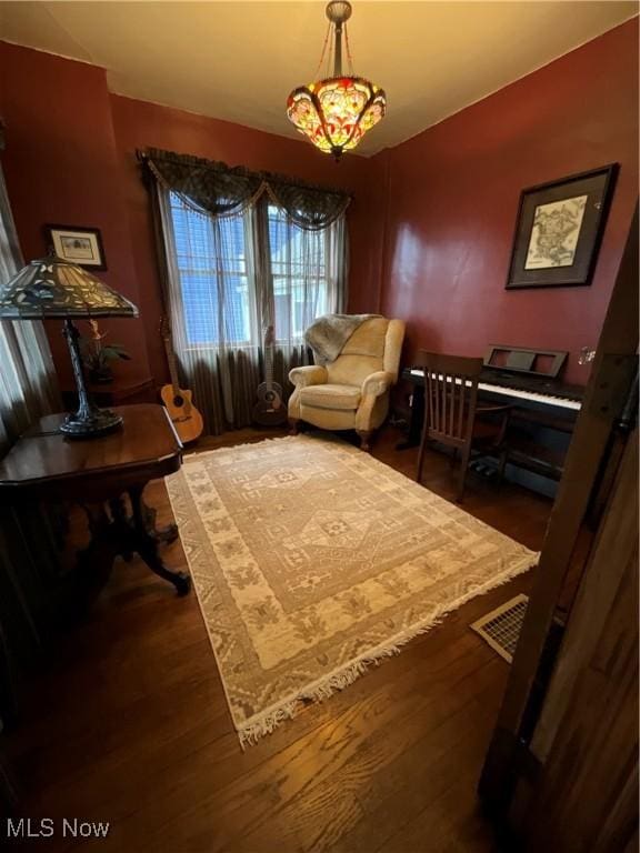 sitting room with wood-type flooring