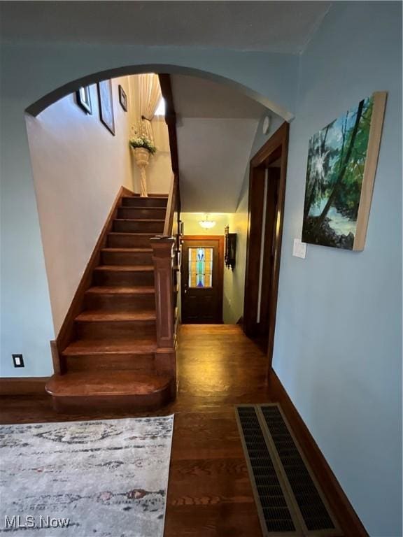 staircase with hardwood / wood-style flooring