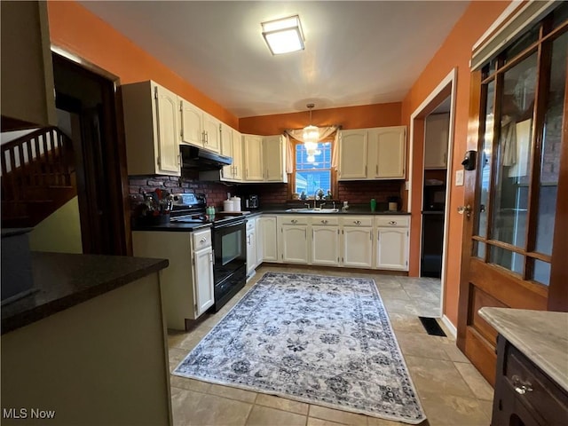 kitchen with black range with electric stovetop, decorative backsplash, sink, and white cabinets