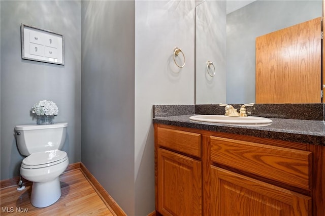 bathroom with vanity, hardwood / wood-style floors, and toilet