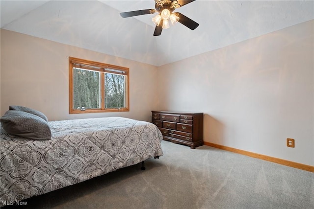 carpeted bedroom featuring vaulted ceiling and ceiling fan