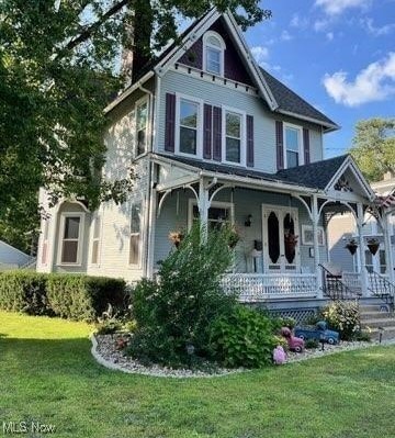 victorian home featuring a front yard and covered porch