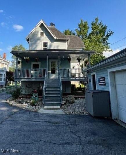 view of front of property with a garage and covered porch