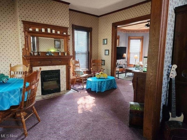 carpeted living room with crown molding and ceiling fan