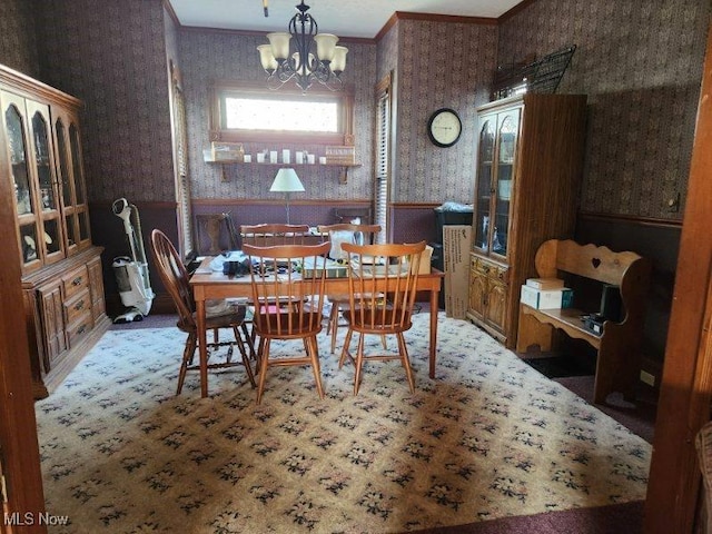 dining area with ornamental molding and a chandelier