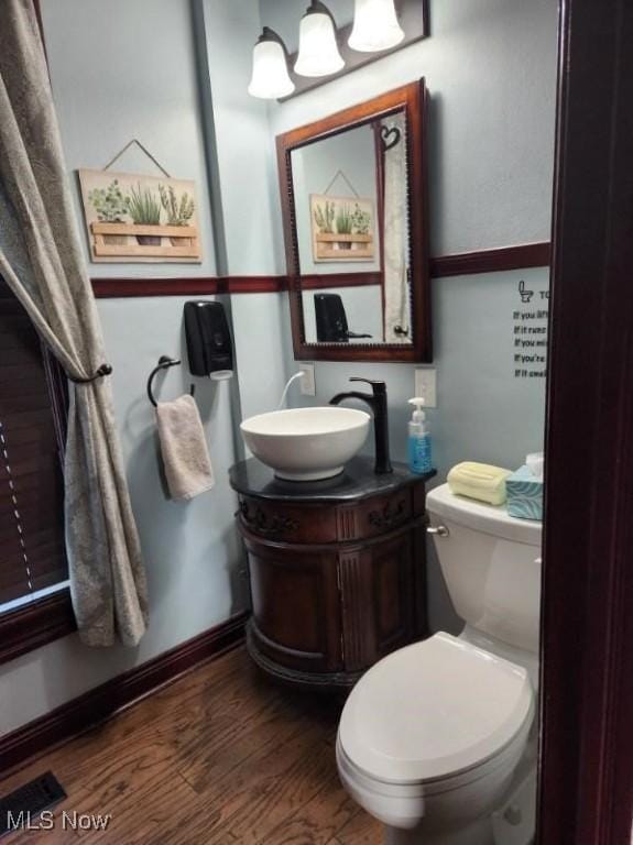 bathroom featuring hardwood / wood-style flooring, vanity, and toilet