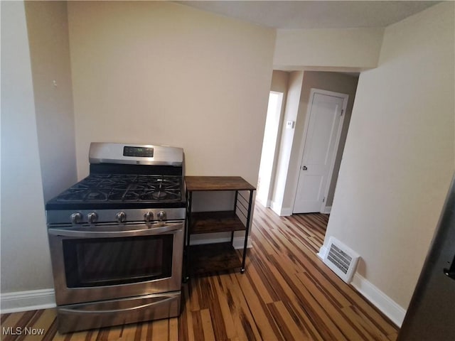 kitchen with stainless steel gas range and wood-type flooring