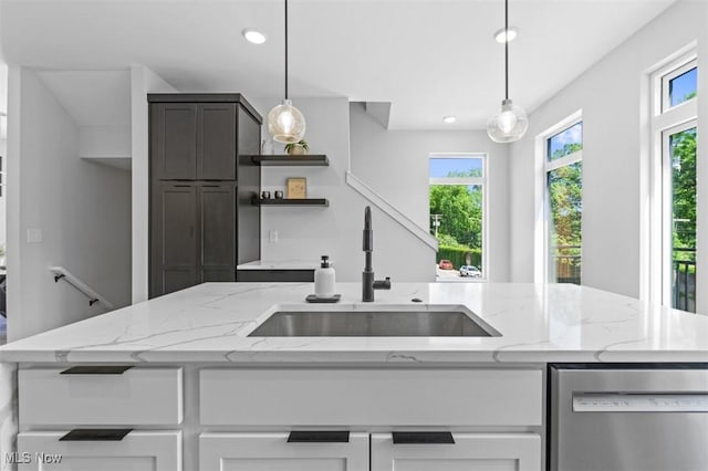 kitchen with dishwasher, light stone countertops, pendant lighting, and white cabinets