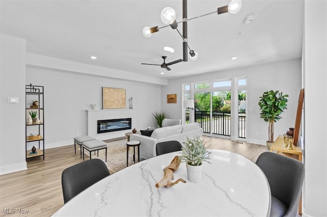 dining room with light hardwood / wood-style floors and ceiling fan