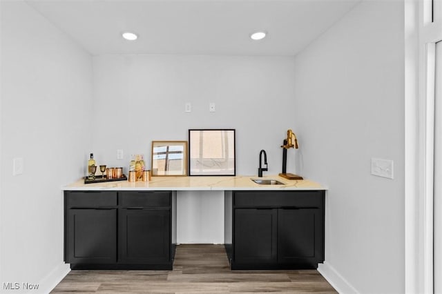 bar featuring wood-type flooring and sink